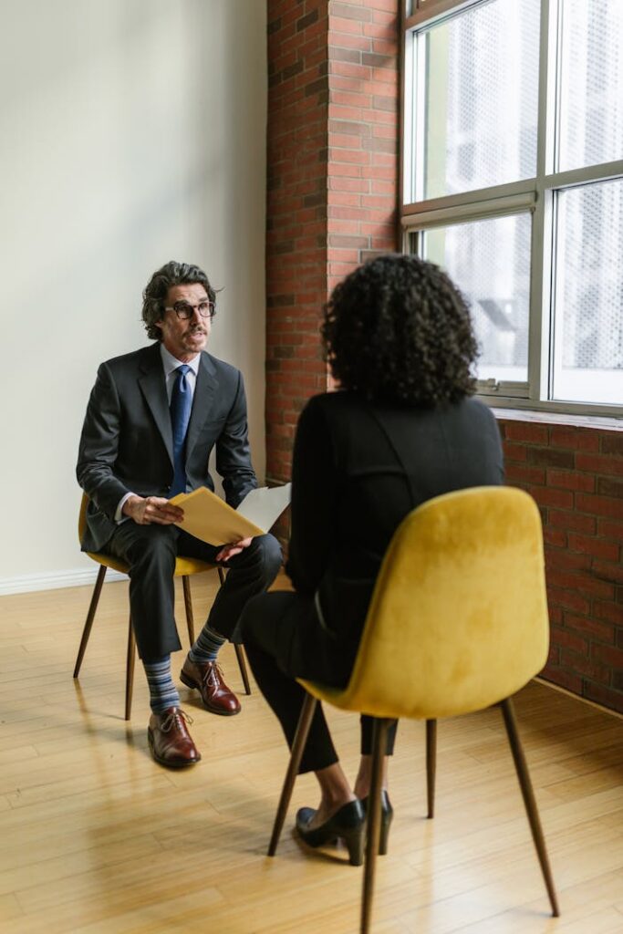 pexels-photo-8124241 Two professionals in a modern office setting having a conversation. Ideal business and corporate representation.